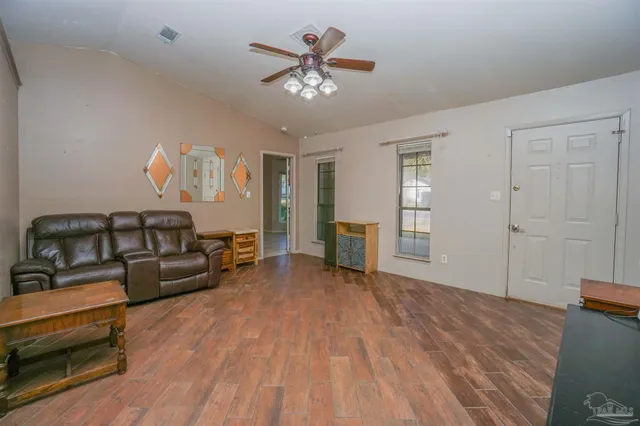 a kitchen with stainless steel appliances granite countertop a sink dishwasher a stove a refrigerator with a dining table and chairs