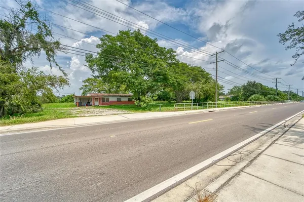 a view of a house with a yard and a street