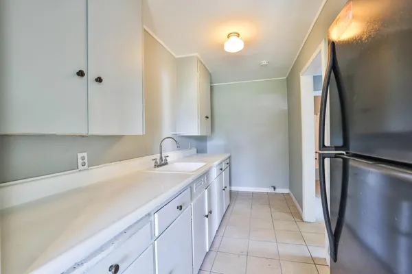 a kitchen with a sink and a refrigerator