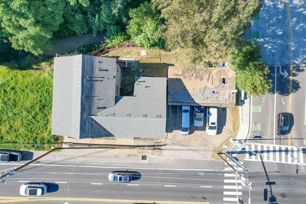an aerial view of a house with garden space and parking