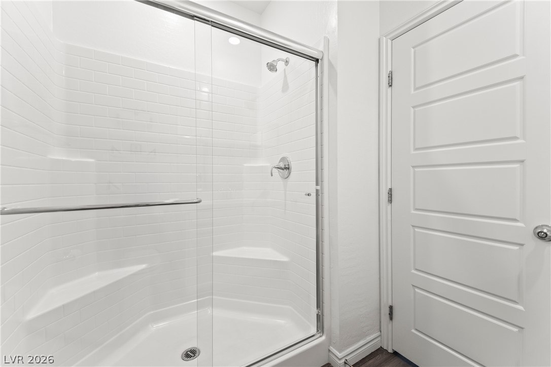 7204 North Decatur Boulevard, Unit 5 North Las Vegas, NV 89084 - Photo 24 of 34 A glass-enclosed shower features classic subway tile and integrated corner shelves.