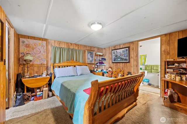 a bedroom with furniture and a large window