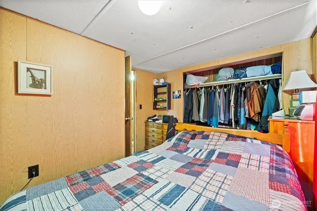 a bed sitting in a bedroom next to a window