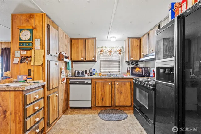 a kitchen with stainless steel appliances granite countertop a refrigerator sink and cabinets