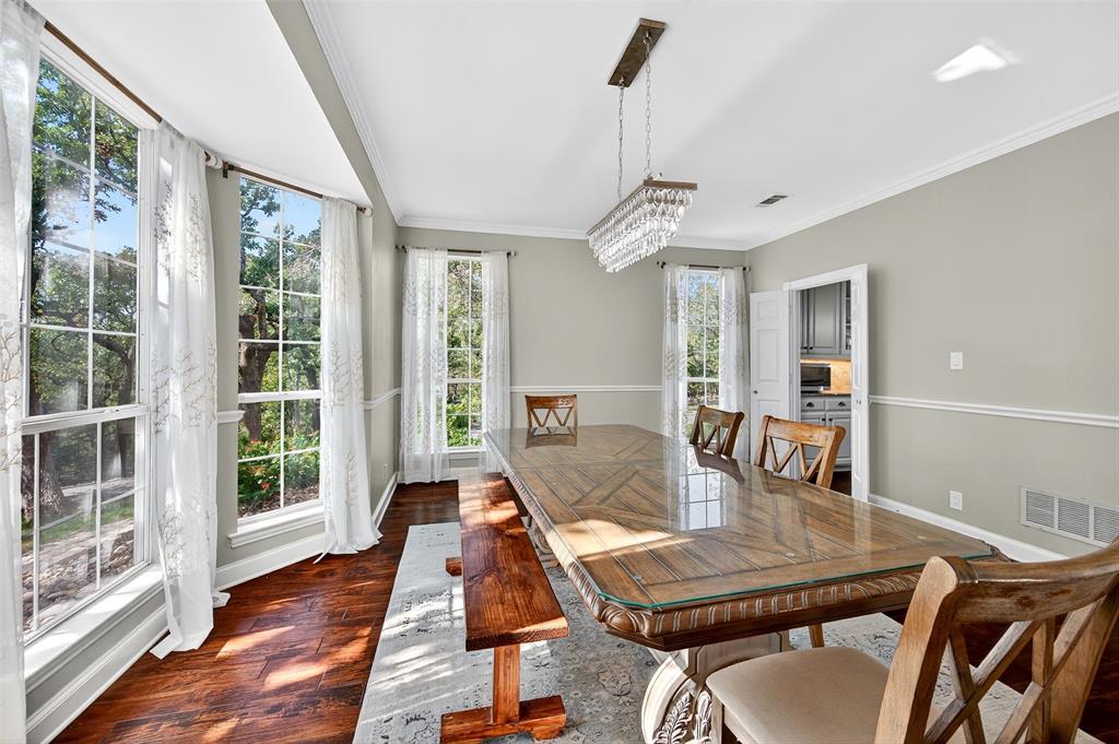 10312 Arvin Hill Road Aubrey, TX 76227 - Photo 13 of 40 a view of a dining room with furniture window and wooden floor