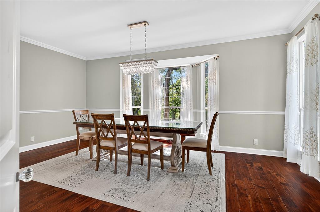 10312 Arvin Hill Road Aubrey, TX 76227 - Photo 14 of 40 a view of a dining room with furniture window and wooden floor