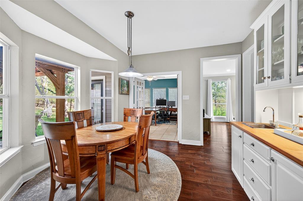 10312 Arvin Hill Road Aubrey, TX 76227 - Photo 17 of 40 a view of a dining room and livingroom with furniture wooden floor a chandelier