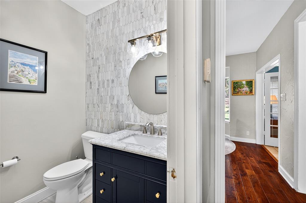 10312 Arvin Hill Road Aubrey, TX 76227 - Photo 24 of 40 a bathroom with a toilet sink and mirror