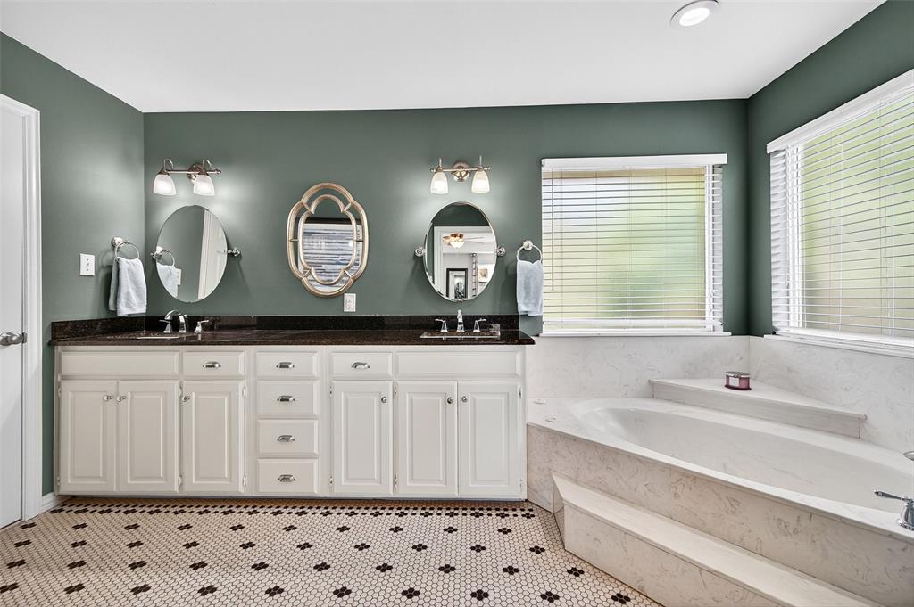 10312 Arvin Hill Road Aubrey, TX 76227 - Photo 27 of 40 a bathroom with a sink and a large mirror