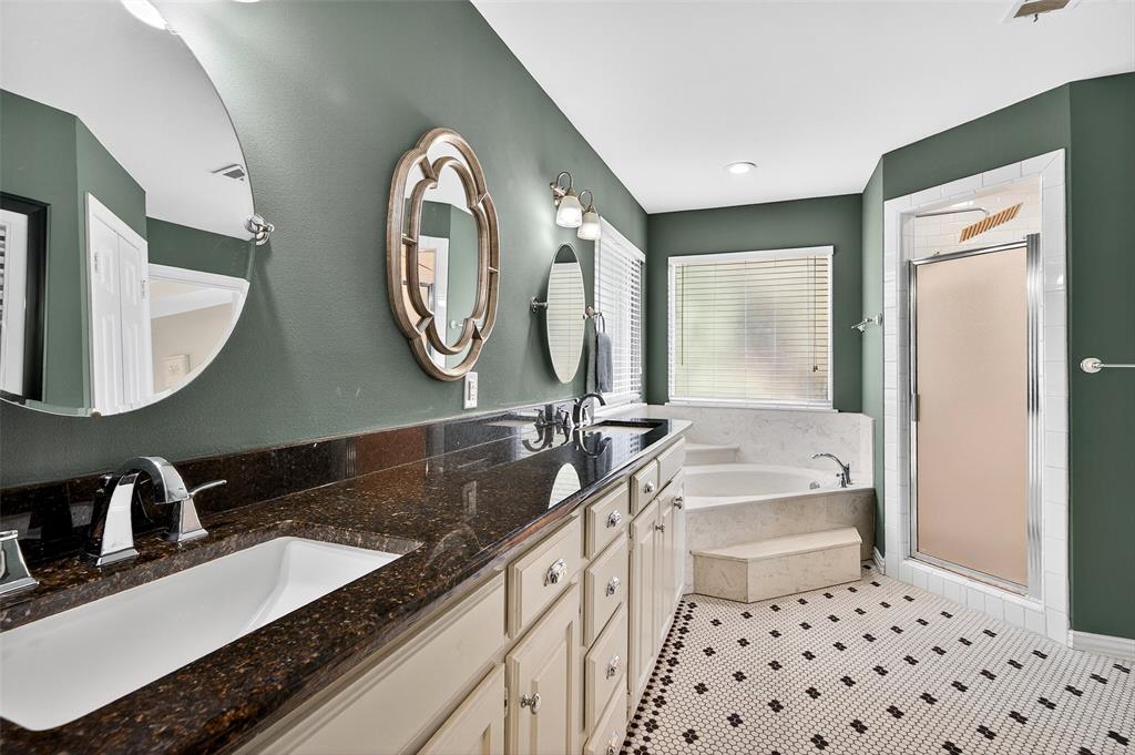 10312 Arvin Hill Road Aubrey, TX 76227 - Photo 28 of 40 a spacious bathroom with a granite countertop double vanity sink a mirror and a