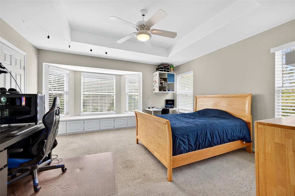 10312 Arvin Hill Road Aubrey, TX 76227 - Photo 30 of 40 a bedroom with a bed dresser and a window