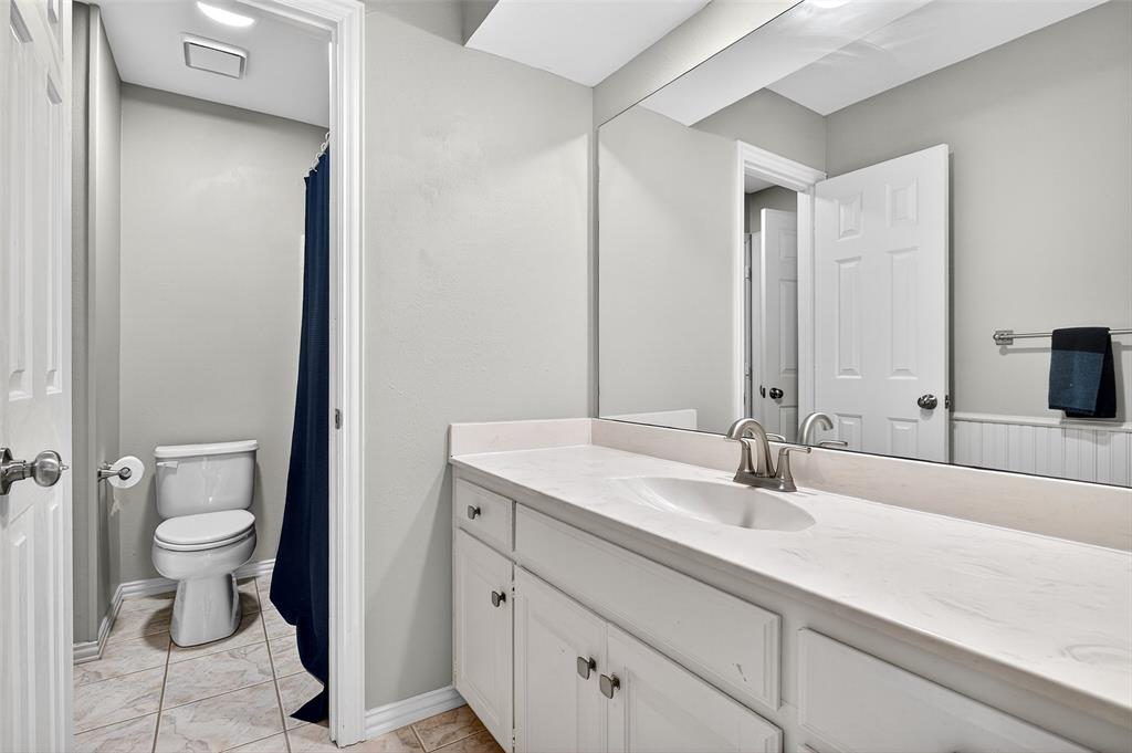 10312 Arvin Hill Road Aubrey, TX 76227 - Photo 31 of 40 a bathroom with a sink toilet and mirror