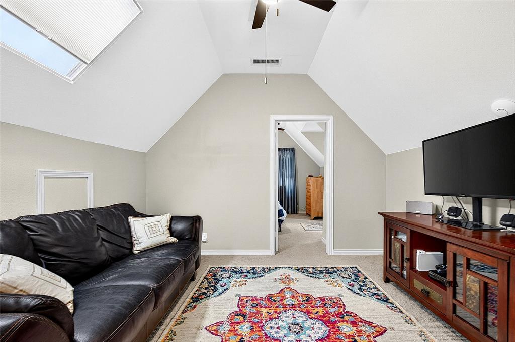 10312 Arvin Hill Road Aubrey, TX 76227 - Photo 33 of 40 a living room with furniture and a flat screen tv