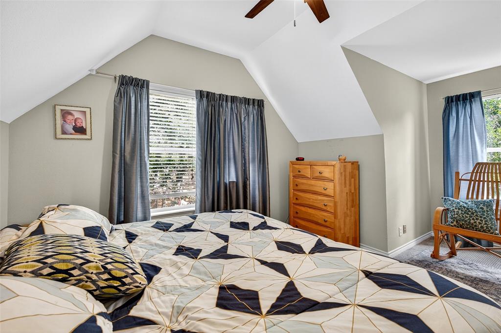 10312 Arvin Hill Road Aubrey, TX 76227 - Photo 34 of 40 a bedroom with a bed and wooden floor