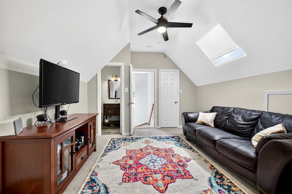 10312 Arvin Hill Road Aubrey, TX 76227 - Photo 35 of 40 a living room with furniture and a flat screen tv