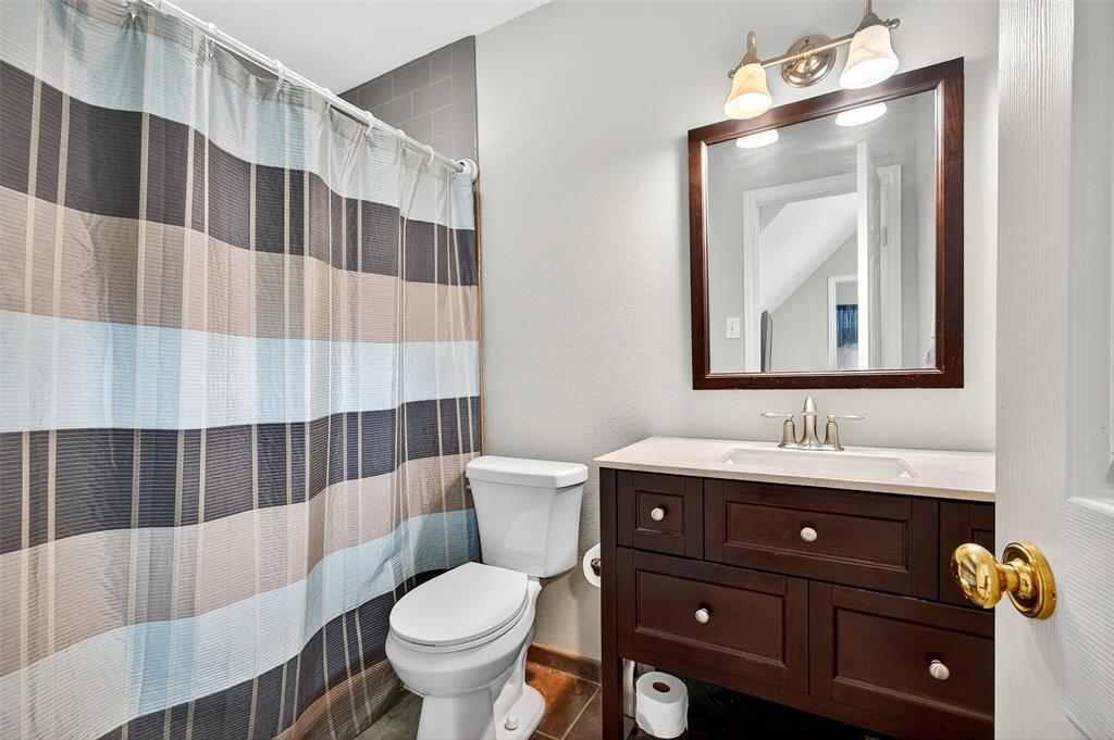 10312 Arvin Hill Road Aubrey, TX 76227 - Photo 36 of 40 a bathroom with a toilet a sink and mirror