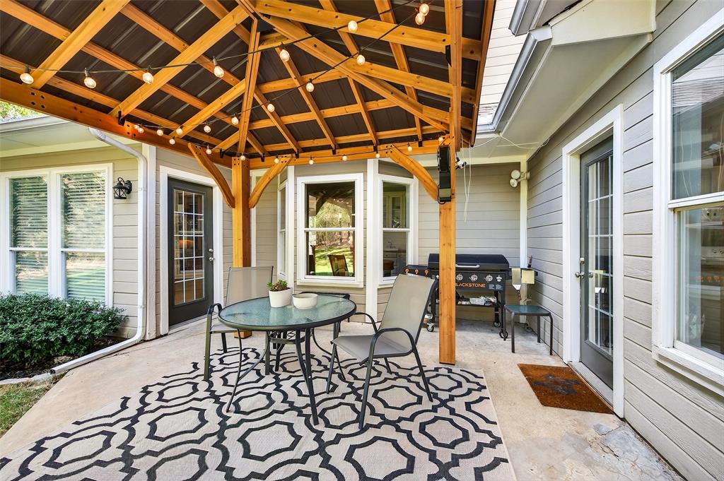 10312 Arvin Hill Road Aubrey, TX 76227 - Photo 8 of 40 a balcony with table and chairs