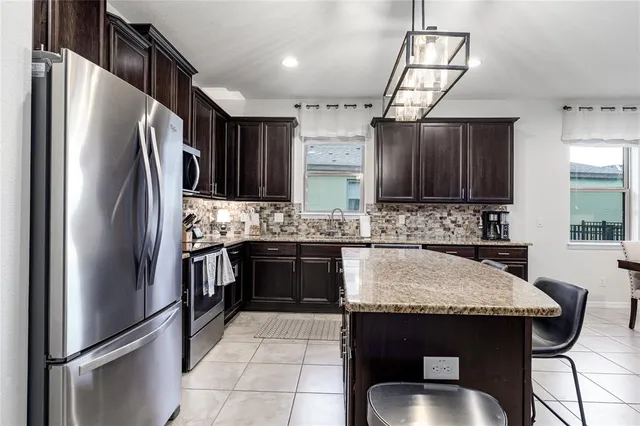 a kitchen with stainless steel appliances a sink stove and refrigerator