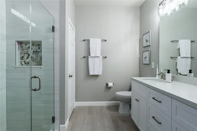 a roof deck with couches and potted plants