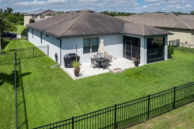 an aerial view of multiple houses with a yard
