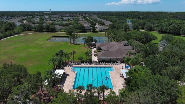 an aerial view of a house with a yard and lake view