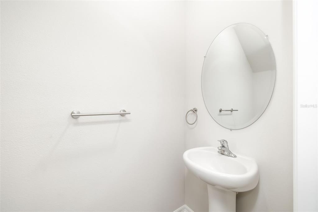 17436 Haysack Terrace Bradenton, FL 34211 - Photo 12 of 53 a bathroom with a sink a mirror and a toilet