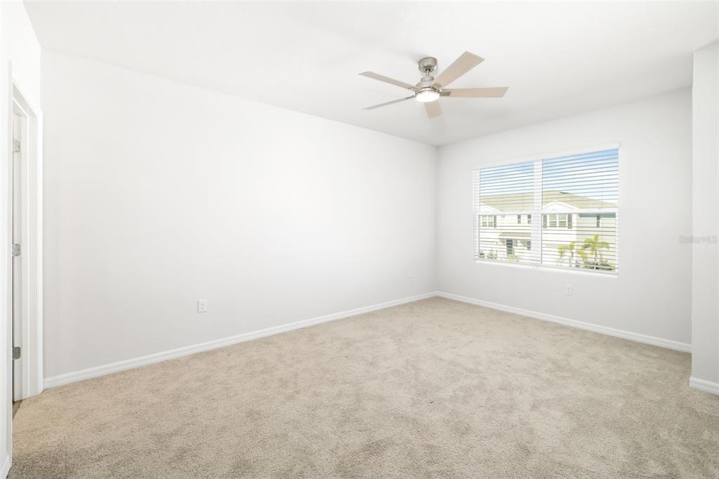 17436 Haysack Terrace Bradenton, FL 34211 - Photo 15 of 53 an empty room with windows and fan