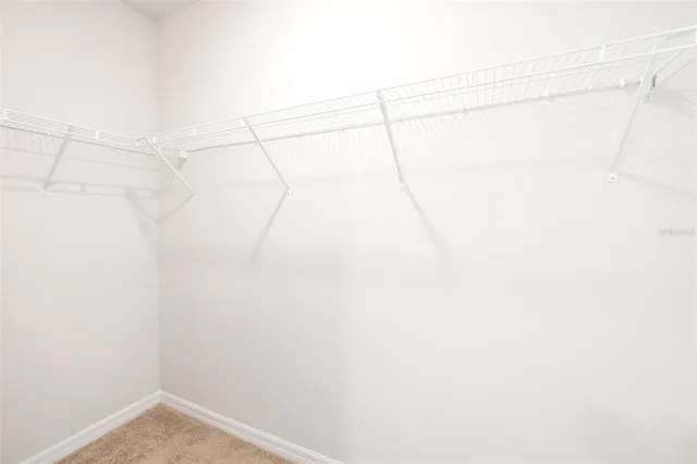 aerial view of a house with a garden space and parking