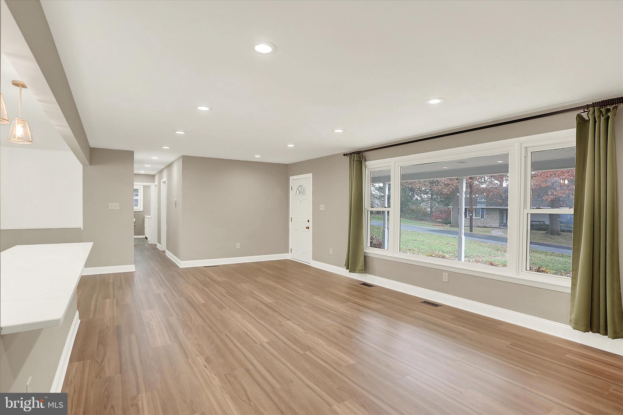 1612 Elbridge Road Harrisburg, PA 17112 - Photo 16 of 39 a view of an empty room with wooden floor and a window