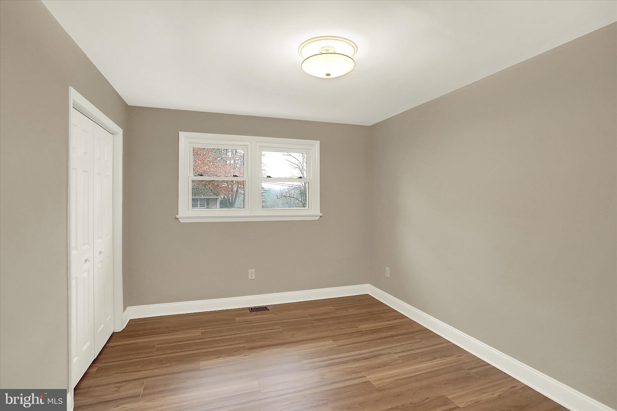 1612 Elbridge Road Harrisburg, PA 17112 - Photo 18 of 39 a view of an empty room with wooden floor and a window