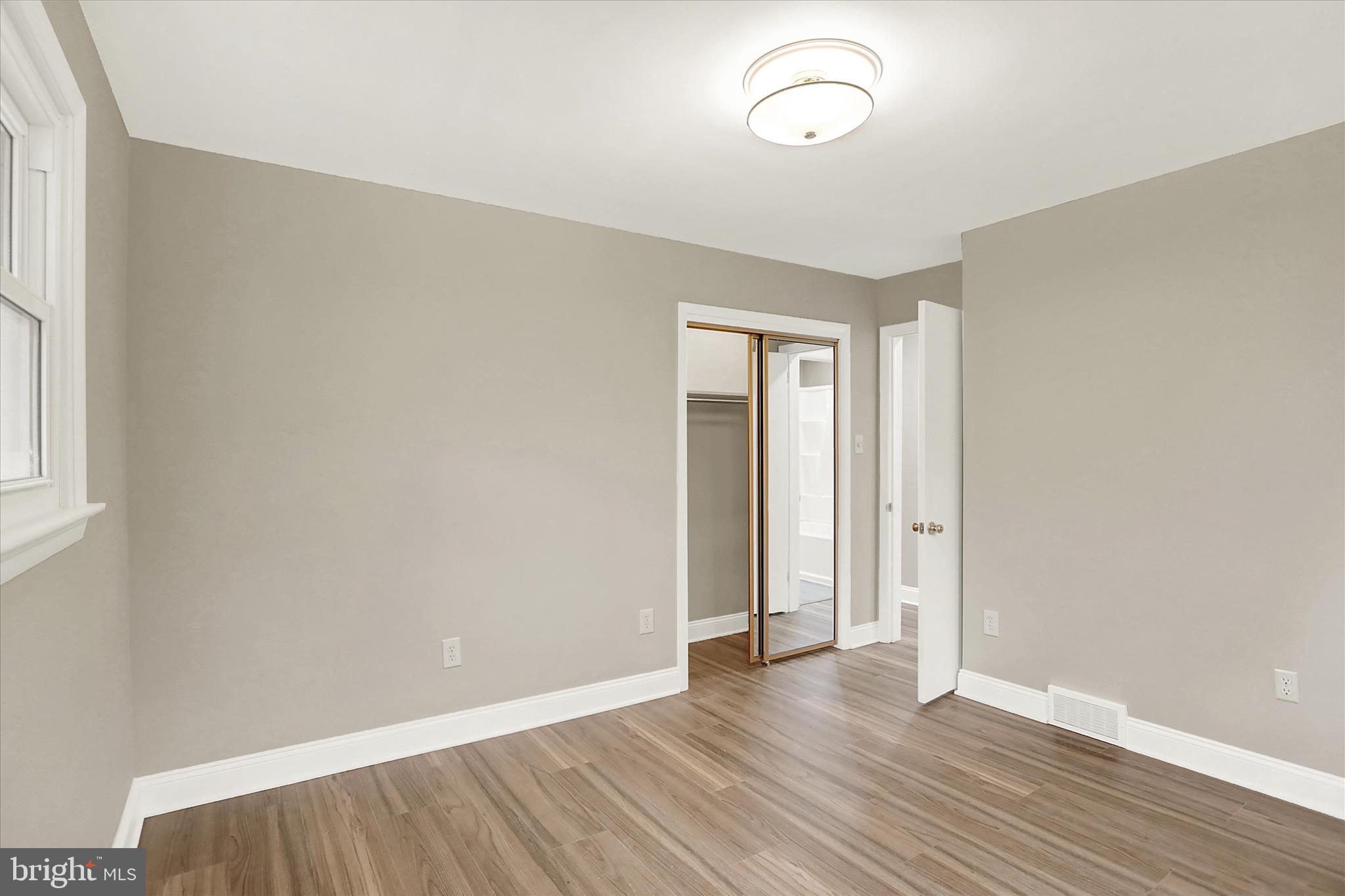 1612 Elbridge Road Harrisburg, PA 17112 - Photo 21 of 39 an empty room with wooden floor and windows