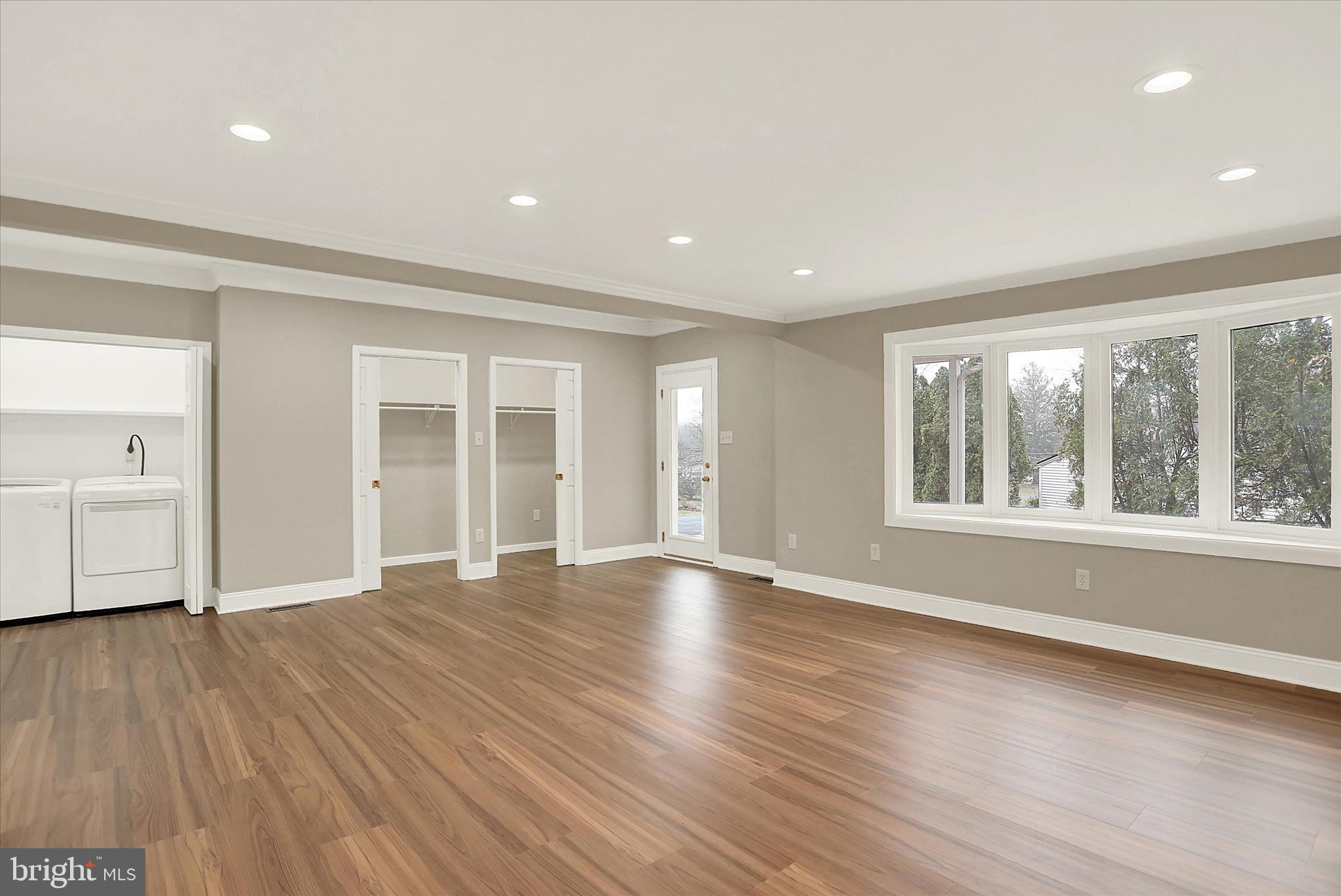 1612 Elbridge Road Harrisburg, PA 17112 - Photo 6 of 39 a view of an empty room with wooden floor and a window