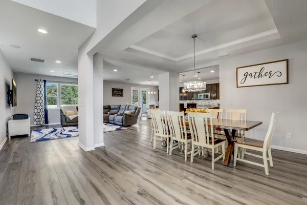 a kitchen with kitchen island a stove a table and chairs in it