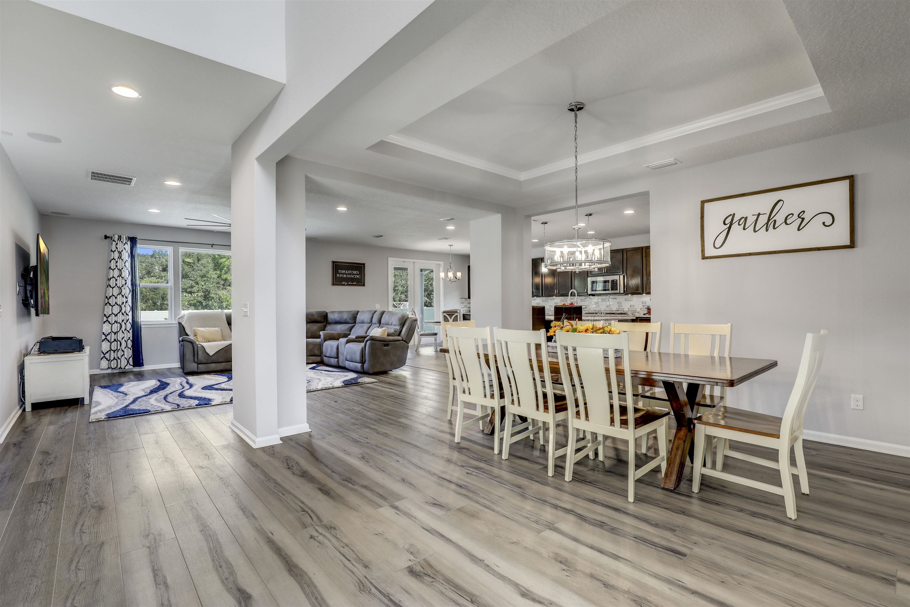 93 Firefly Trace St. Augustine, FL 32092 - Photo 17 of 76 a dining room with furniture wooden floor a rug and a painting