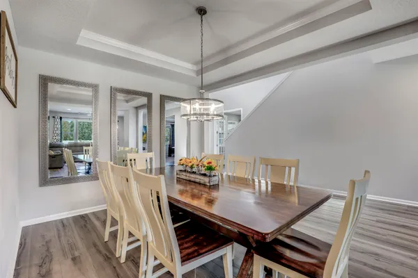 a large kitchen with stainless steel appliances granite countertop a large counter top and a refrigerator