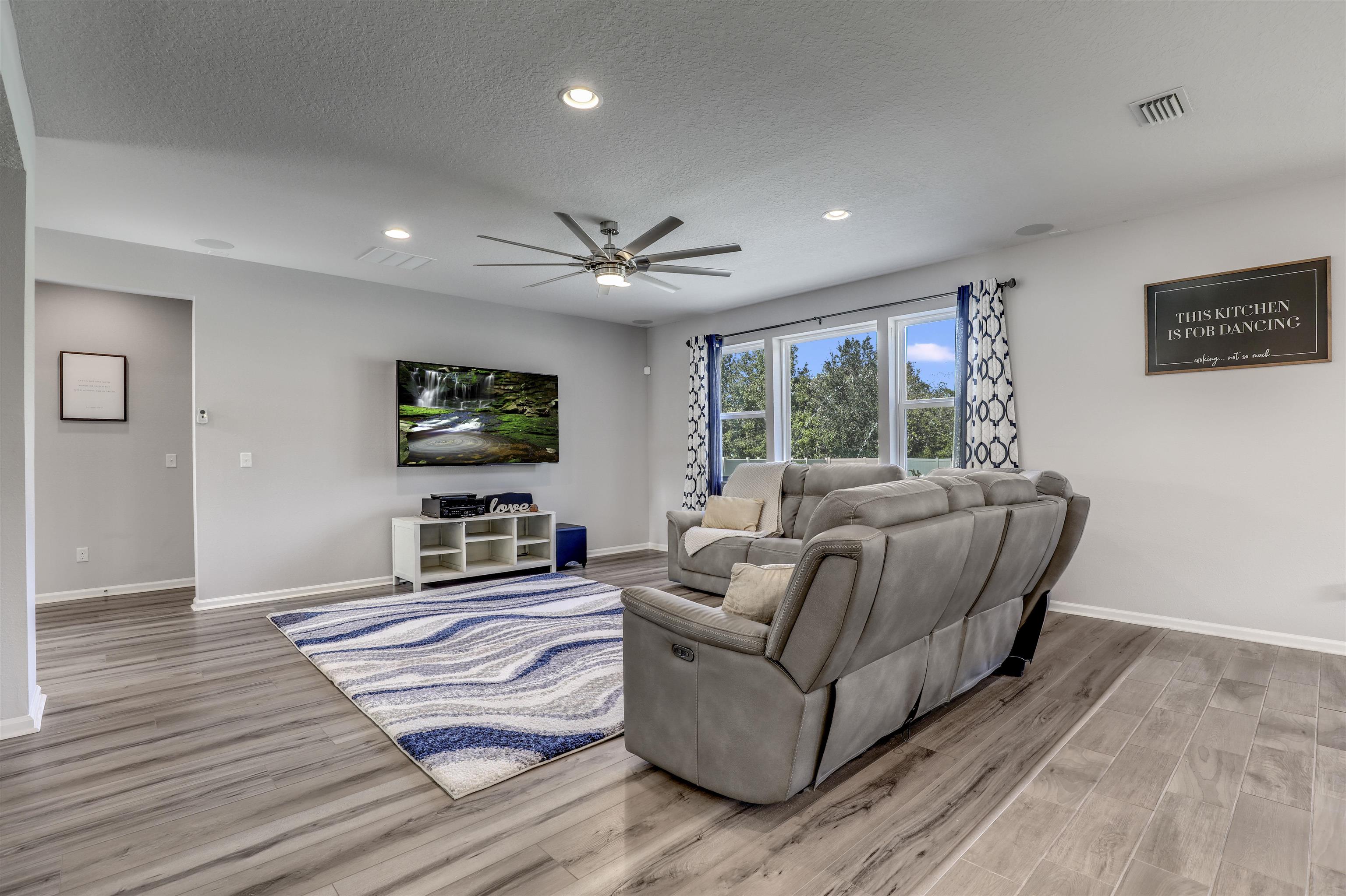 93 Firefly Trace St. Augustine, FL 32092 - Photo 23 of 76 a living room with furniture and a flat screen tv