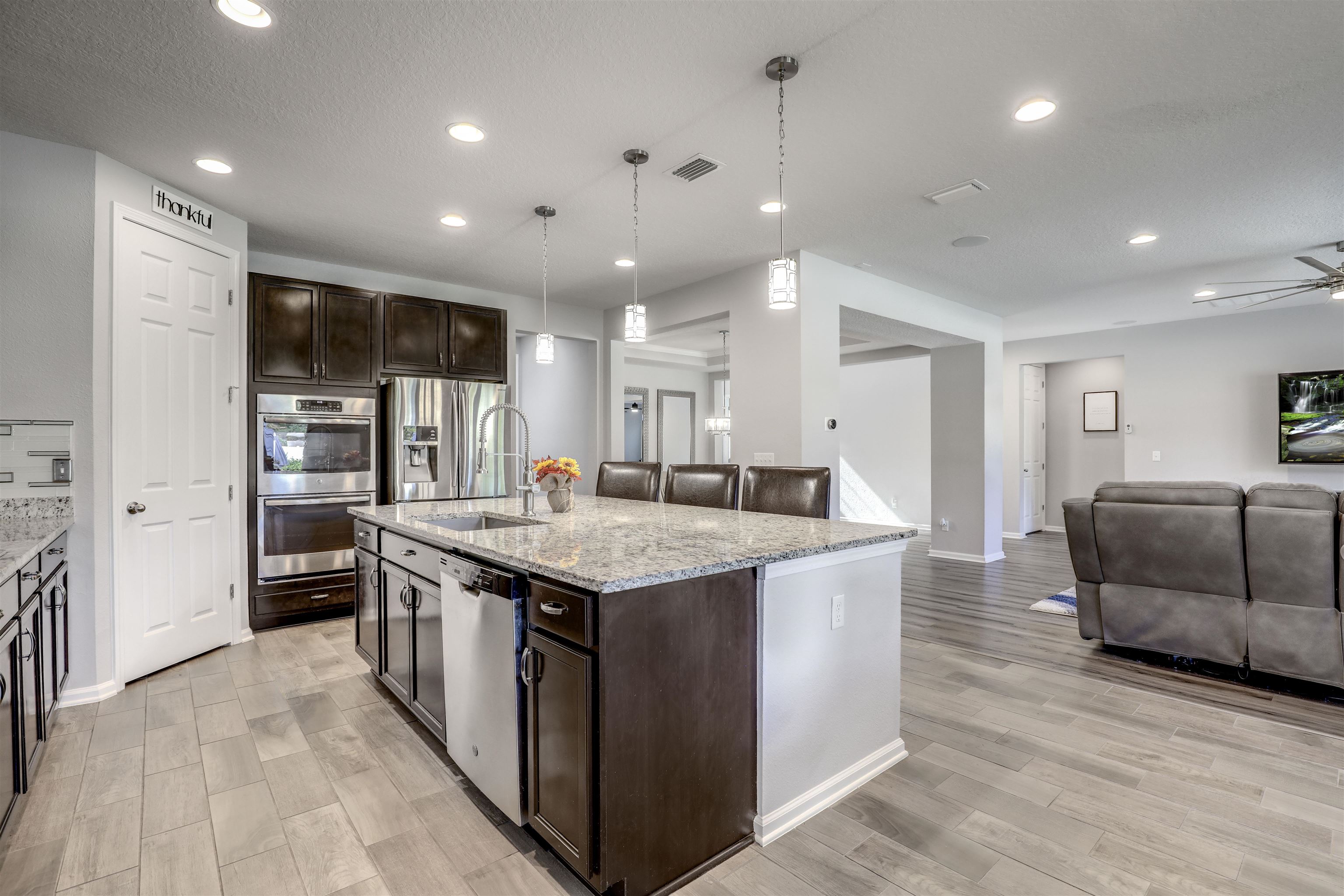 93 Firefly Trace St. Augustine, FL 32092 - Photo 27 of 76 a large kitchen with stainless steel appliances granite countertop a large counter top and a refrigerator