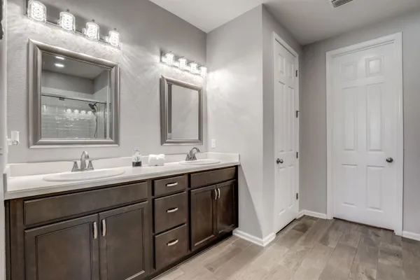 a patio with glass top table and chairs