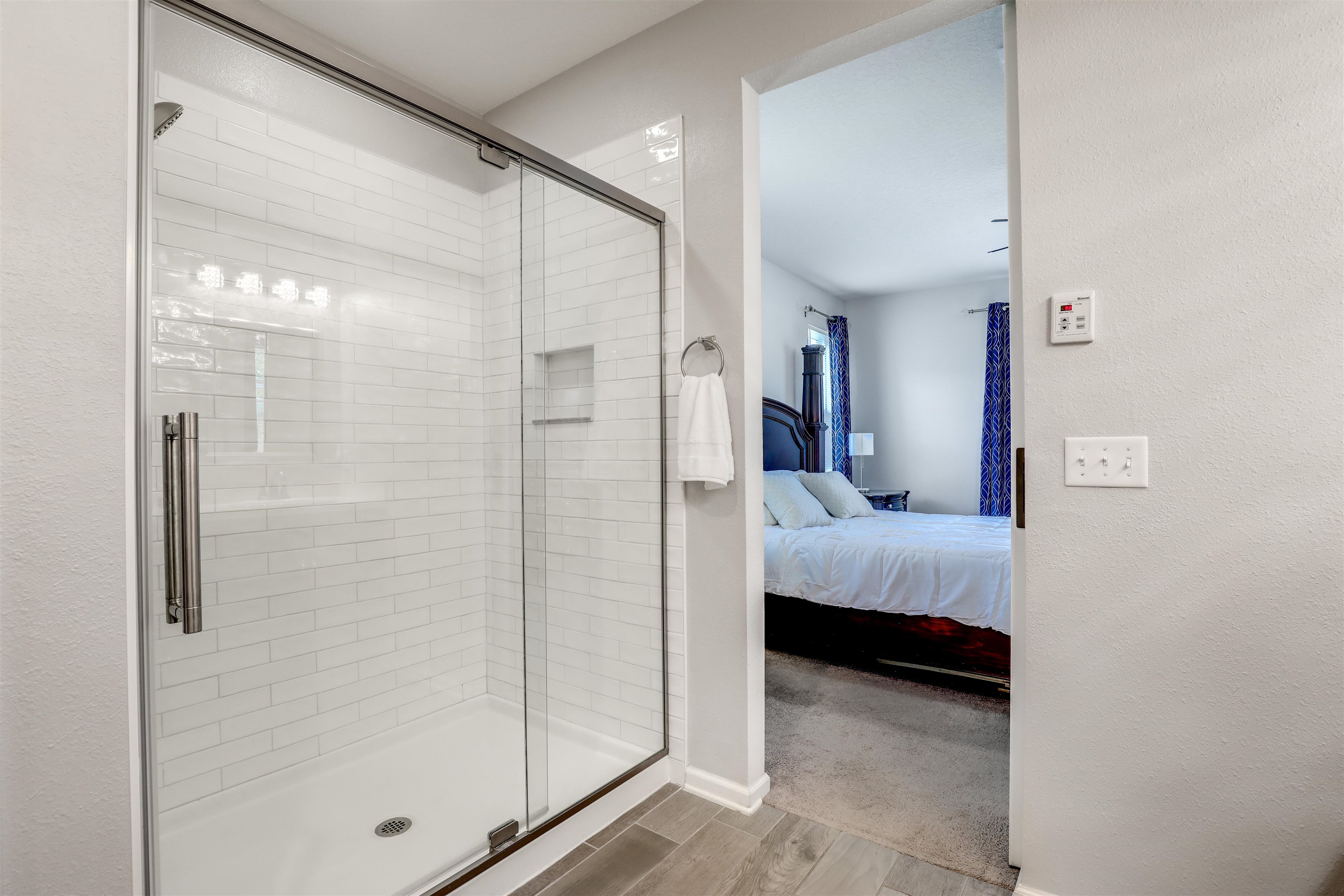 93 Firefly Trace St. Augustine, FL 32092 - Photo 35 of 76 a bedroom with a bed and a glass door shower