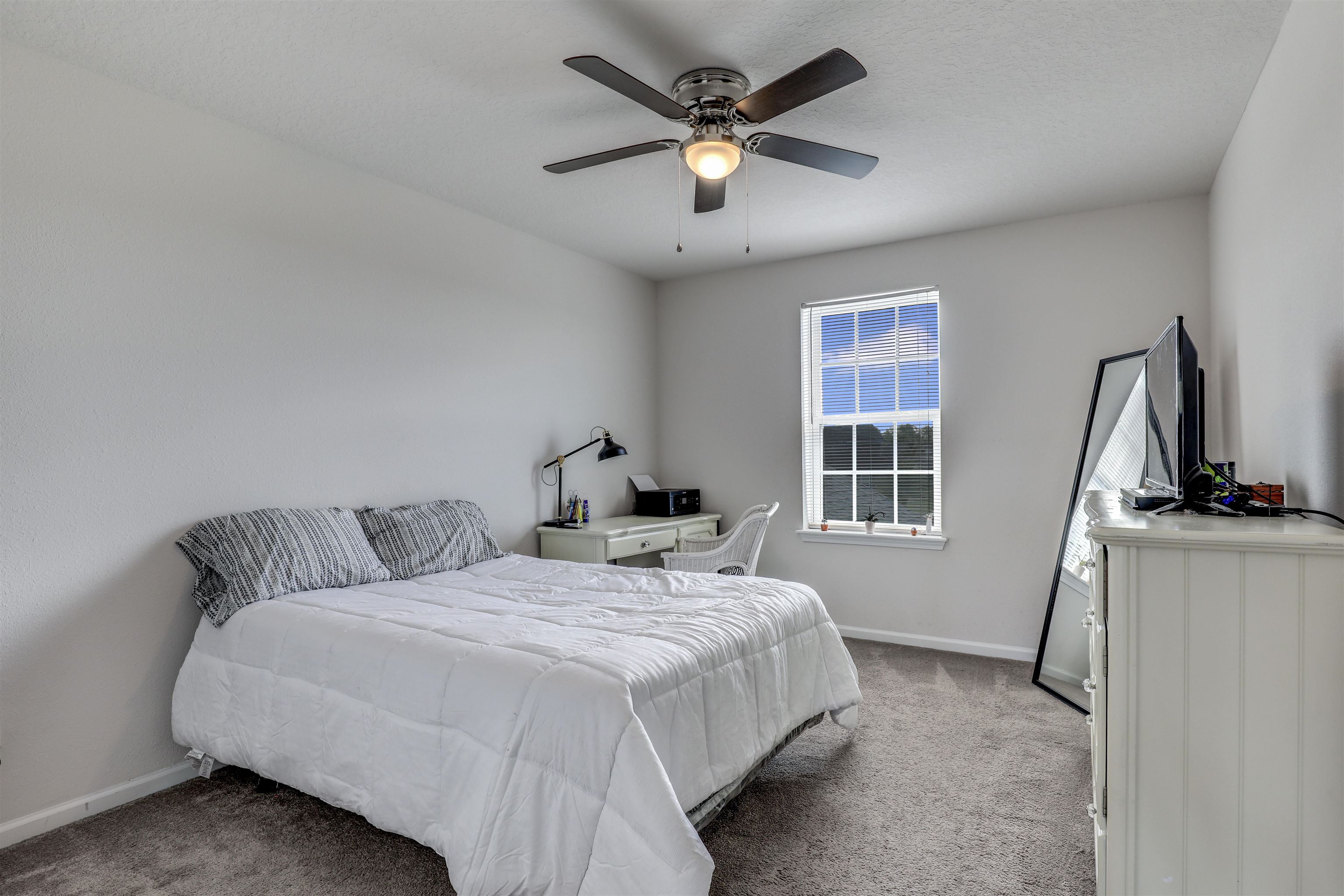 93 Firefly Trace St. Augustine, FL 32092 - Photo 44 of 76 a bedroom with a bed flat screen tv and a window