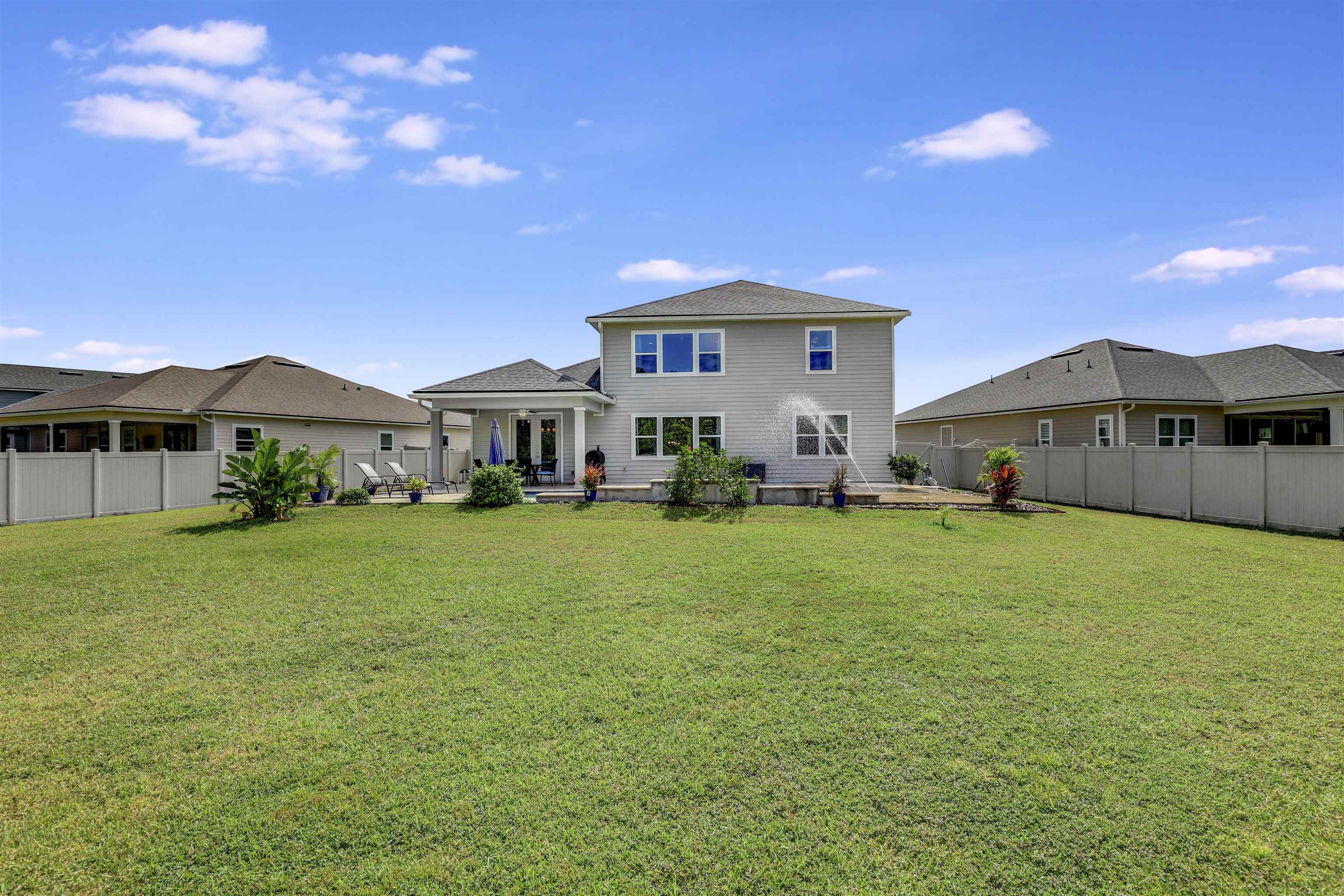 93 Firefly Trace St. Augustine, FL 32092 - Photo 56 of 76 a front view of a house with a garden