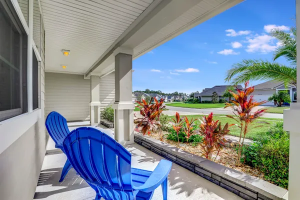 a dining room with furniture wooden floor a rug and a painting