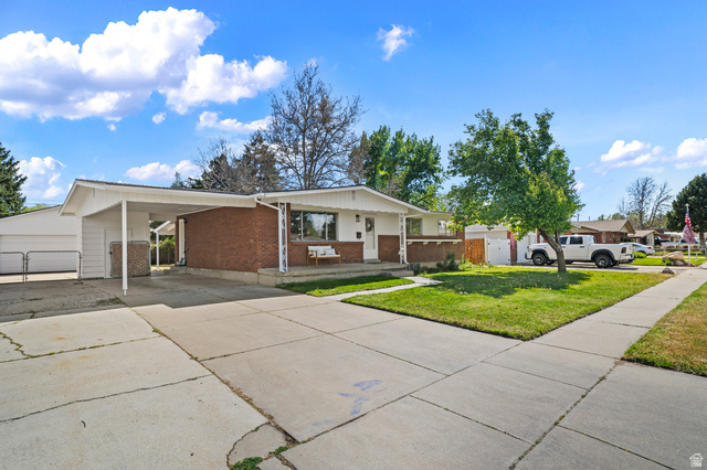 2267 West 4350th Street South Roy, UT 84067 - Photo 4 of 32 View of front of property featuring brick siding, driveway, an attached carport, and covered porch
