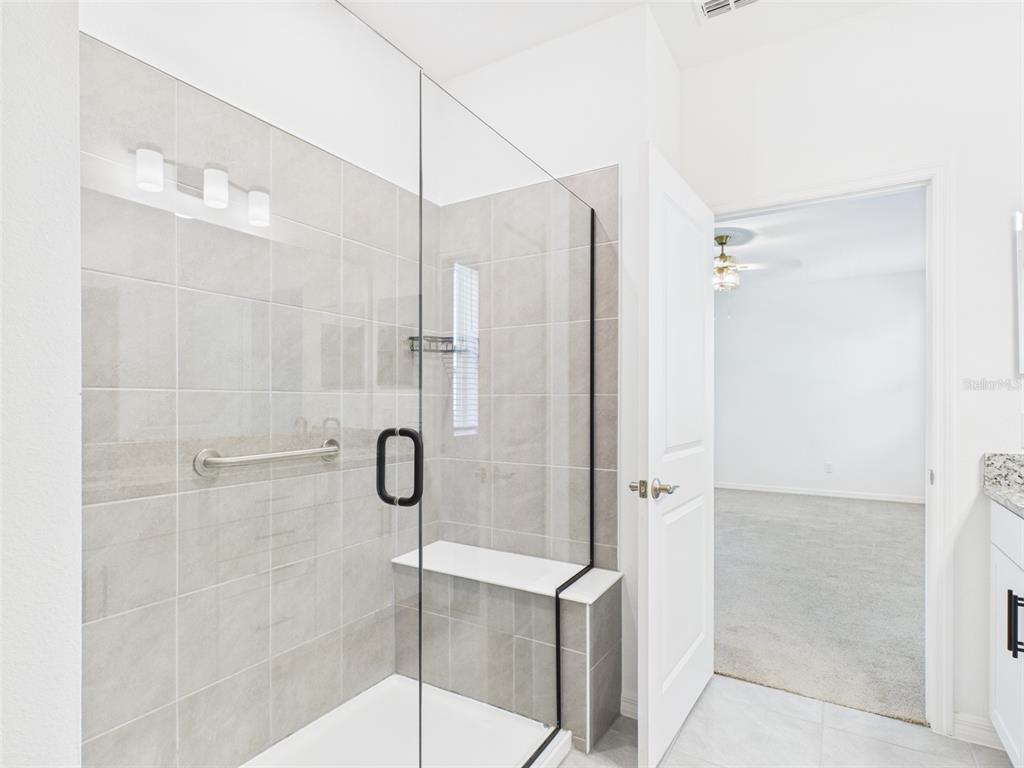 2033 Emerald Springs Drive Apopka, FL 32712 - Photo 19 of 49 a bathroom with a glass door shower