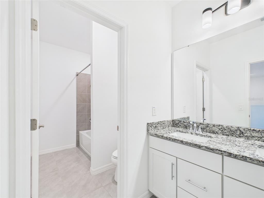 2033 Emerald Springs Drive Apopka, FL 32712 - Photo 24 of 49 a bathroom with a granite countertop sink and a mirror