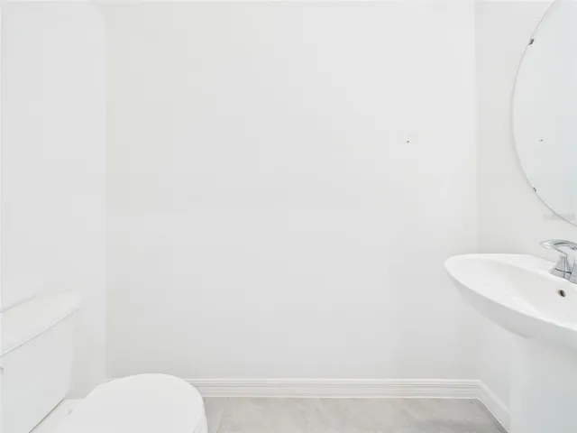 an empty room with a chandelier fan