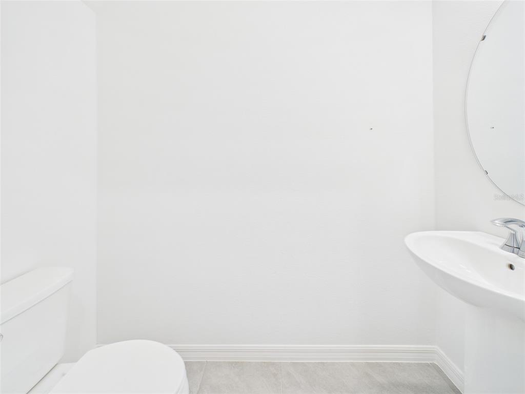 2033 Emerald Springs Drive Apopka, FL 32712 - Photo 30 of 49 a bathroom with a toilet and a sink