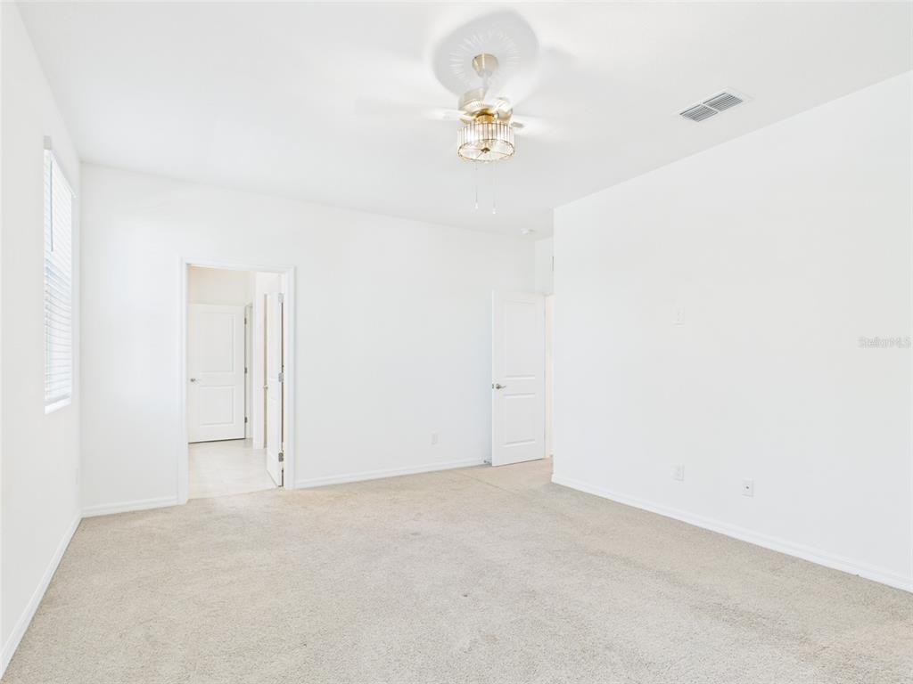 2033 Emerald Springs Drive Apopka, FL 32712 - Photo 32 of 49 an empty room with a chandelier fan