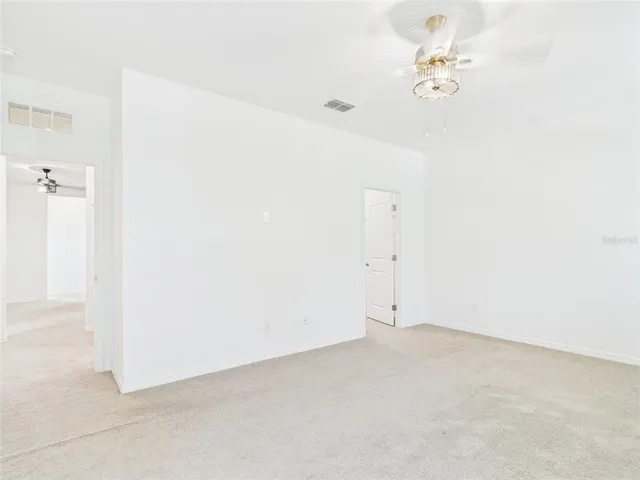 a bathroom with a granite countertop sink two mirror and shower