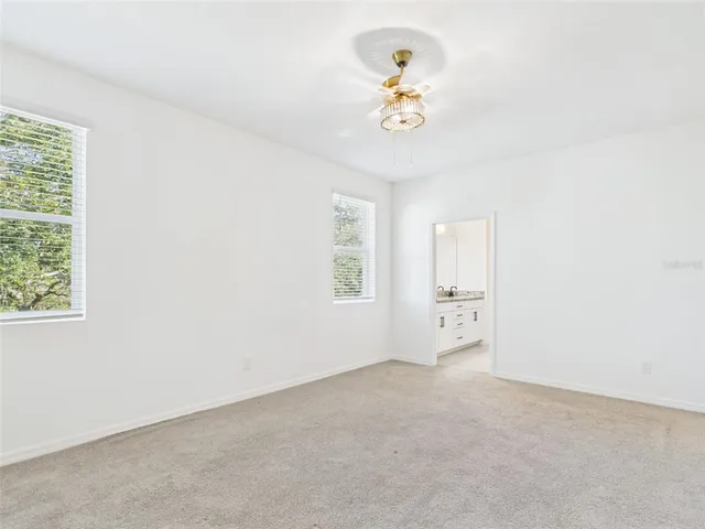 a white toilet sitting next to a white cabinet